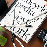 A Blackwing x New York Magazine (Set of 12) and pencils on a table, perfect for crossword puzzles enthusiasts.