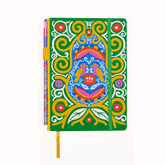A hardcover notebook with a vibrant green cover decorated with a colorful Frida Kahlo spiral, bird, and floral illustration, featuring a green elastic closure band and a yellow bookmark ribbon with a matching pencil in the pencil holster.