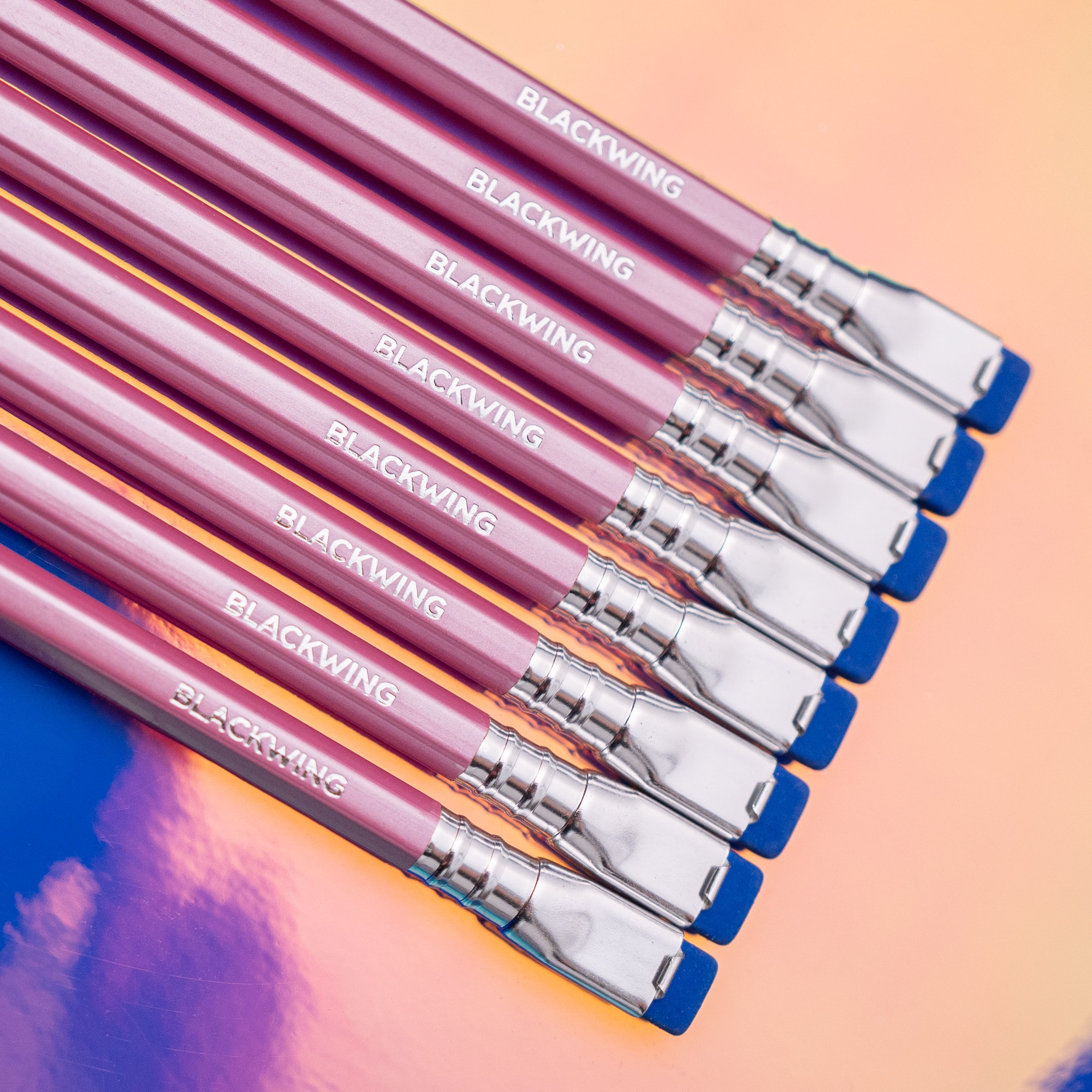 A set of Blackwing Pearl - Pink pencils on a colorful surface.