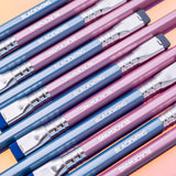A group of pink and blue pencils on a colorful background, featuring a Blackwing Pearl - Pink (Set of 12) pencil.