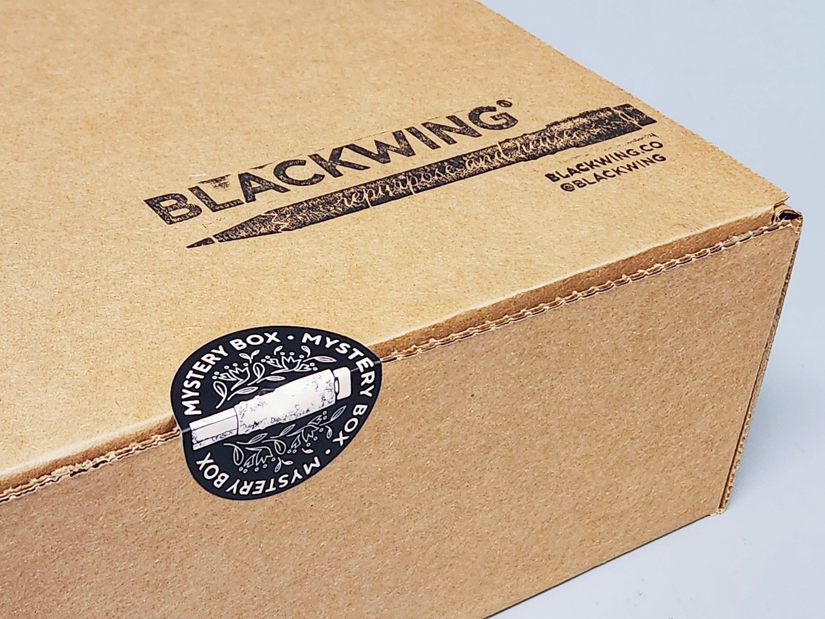 A brown Blackwing Mystery Box with a Blackwing logo on it.