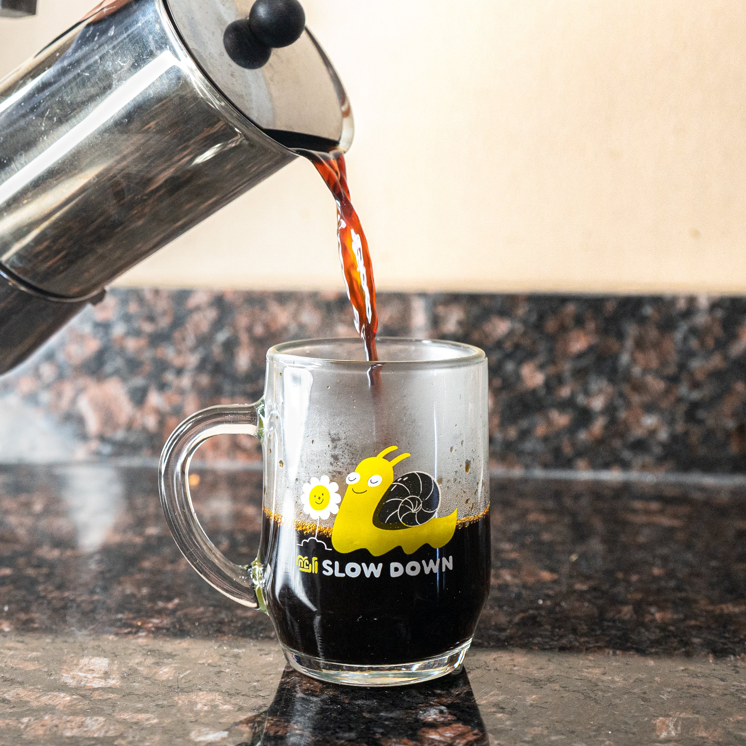 A Blackwing Slow Down Snail Mug being filled with coffee.