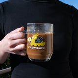 A person holding a Blackwing Slow Down Snail Mug of coffee.