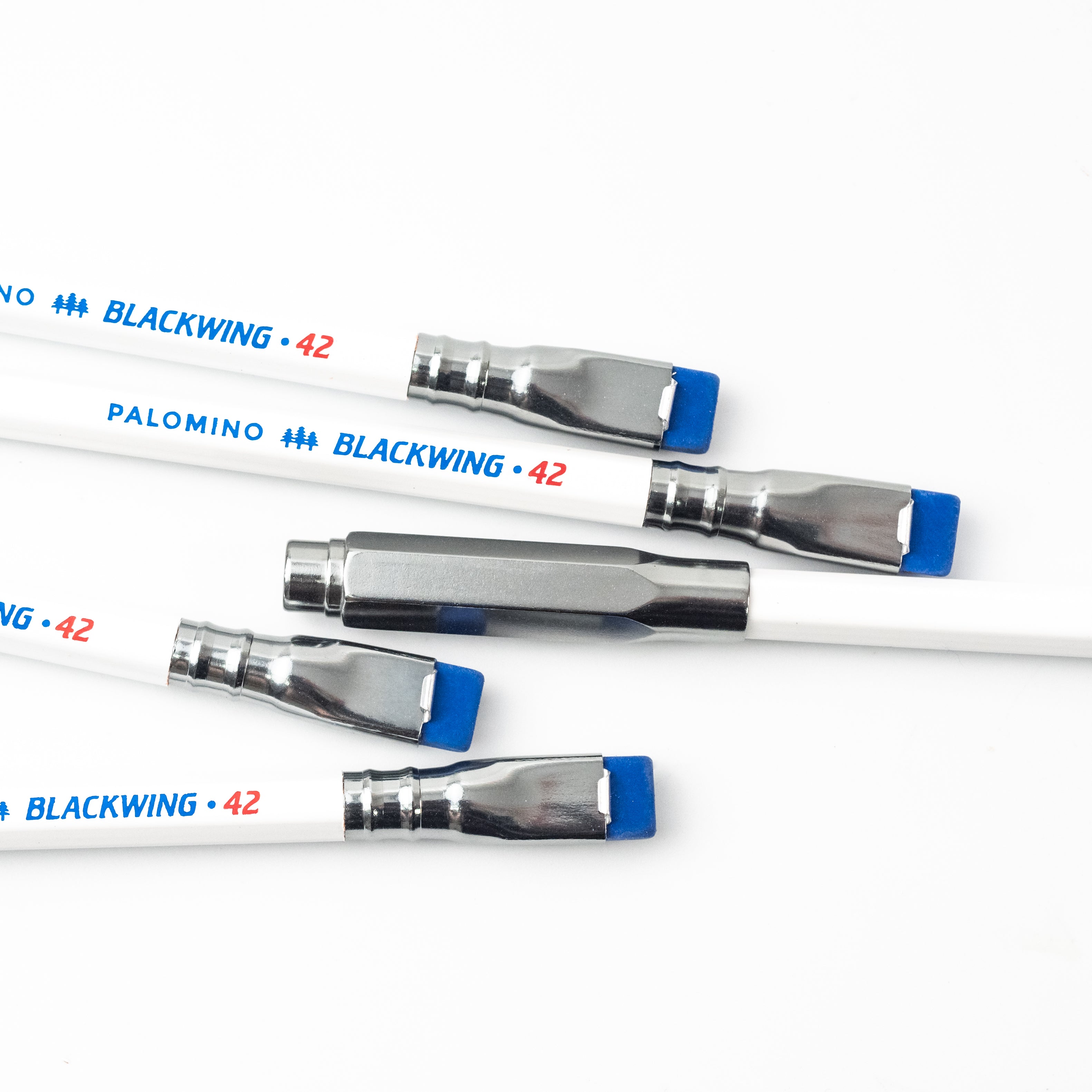 A group of white and blue pens, Blackwing 42 Point Guard - Road Gray (Dark Silver).