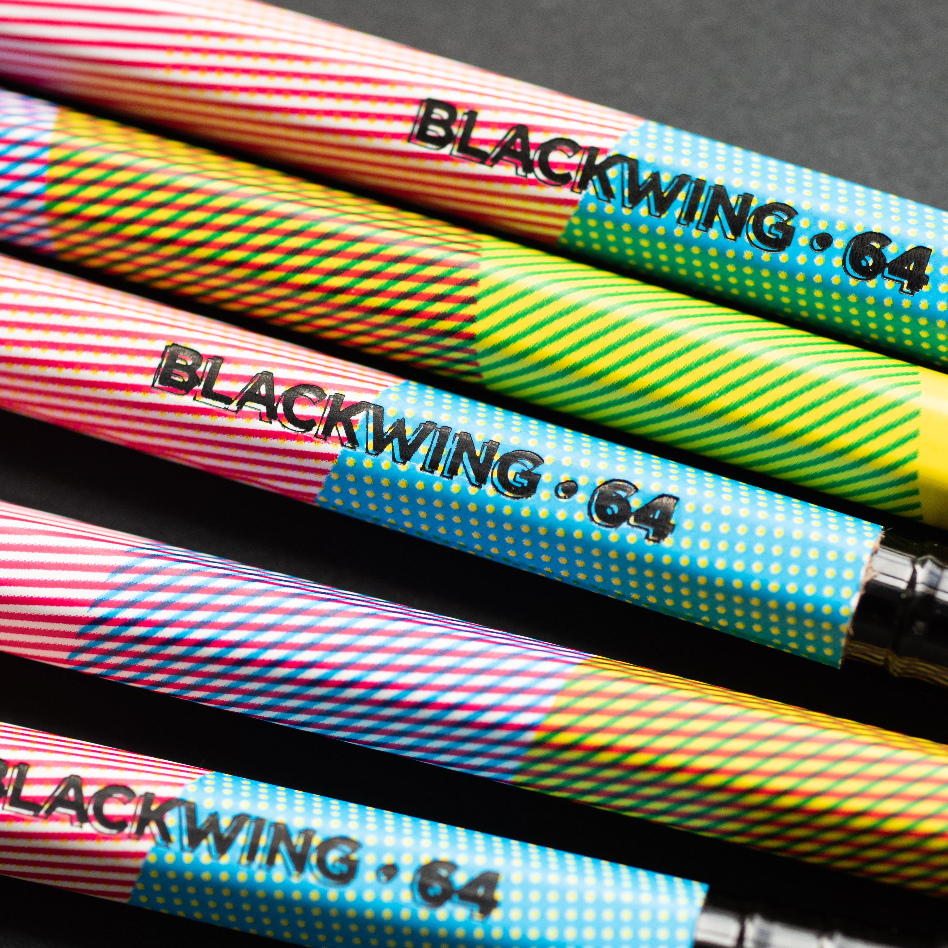 A set of Blackwing Volume 64 pencils on a black surface, perfect for creating comic book art.