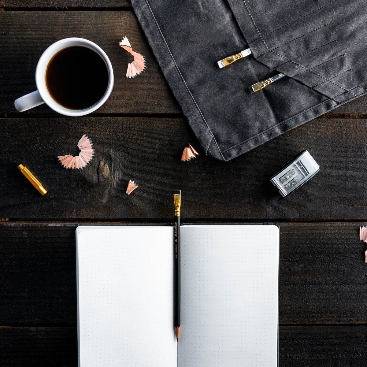 Blackwing Slate Notebook, Legacy Model on desk with pencil, sharpener, and cup of coffee Blackwing Slate Notebook, Legacy Model on desk with pencil, sharpener, and cup of coffee