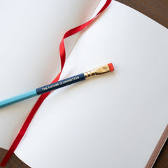 Blackwing x Obey Giant Slate notebook, open with pencil sitting on top Blackwing x Obey Giant Slate notebook, open with pencil sitting on top