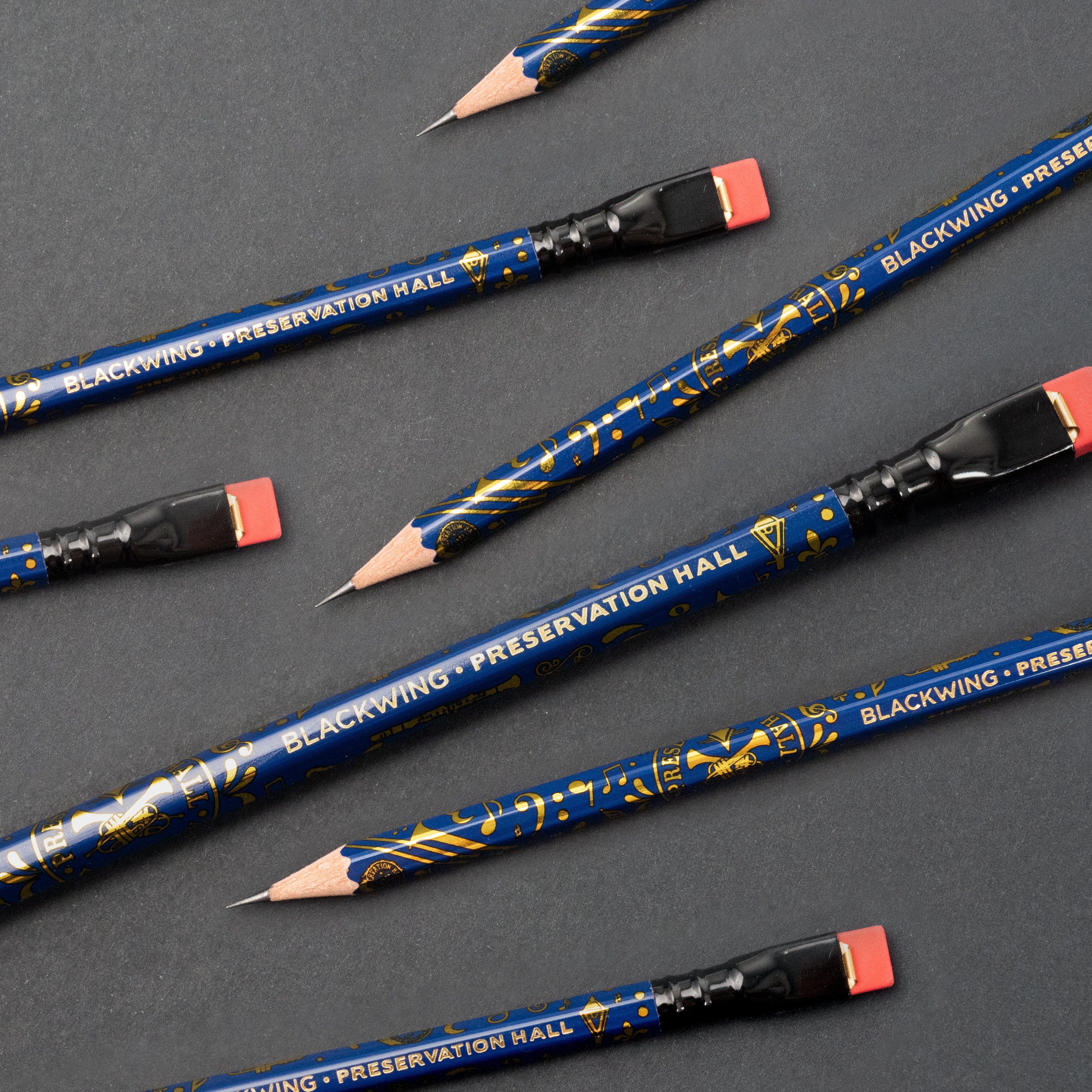 A stack of Blackwing X Preservation Hall (Set of 12) pencils resting on one another.