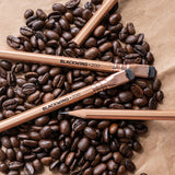 Blackwing Volume 200 pencils and coffee beans on a brown paper, perfect for sparking creativity.
