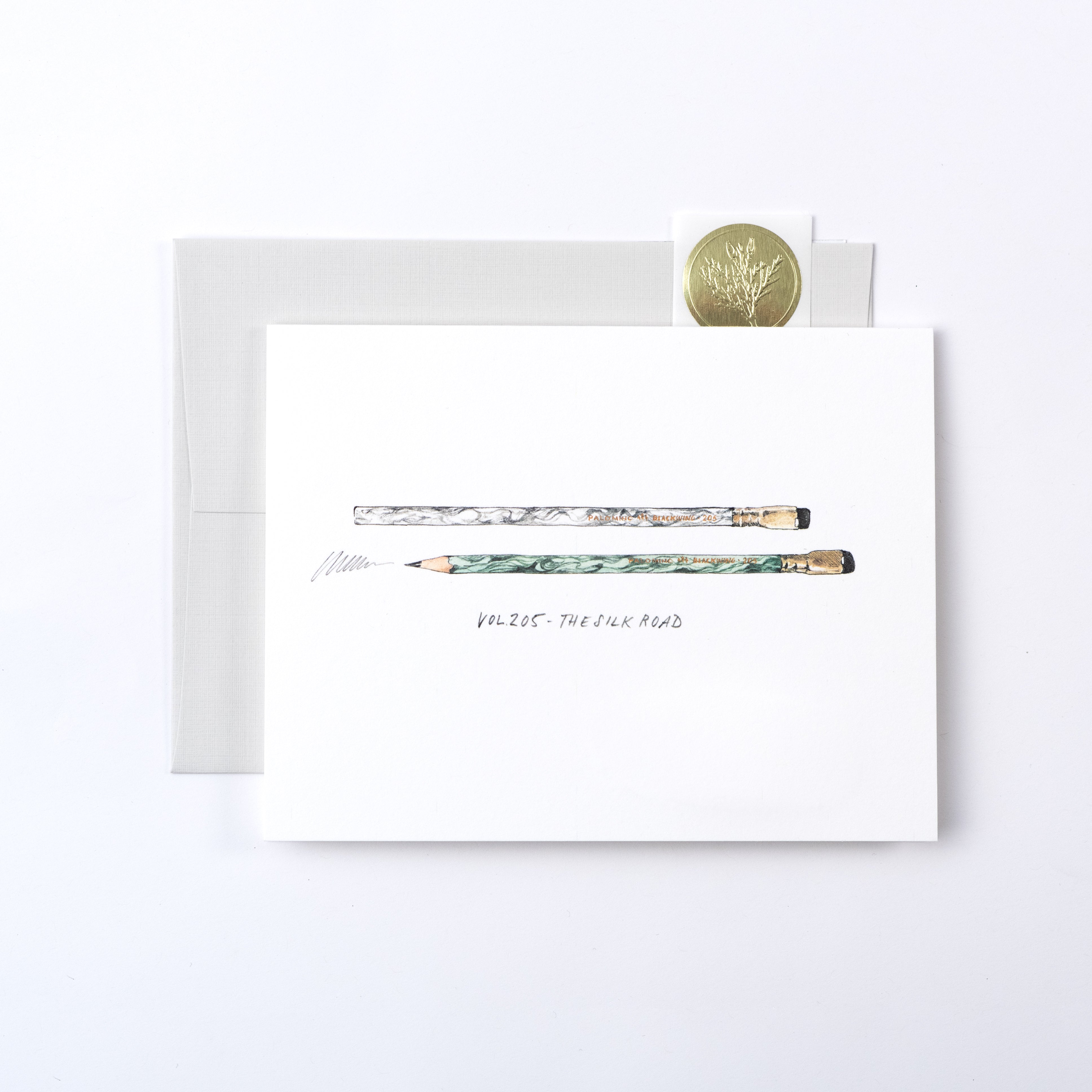 A white card with pencils and a coin from the Blackwing Volumes Notecards - Year 2 series.