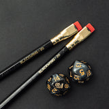Two Blackwing Volume 20 (Set of 12) pencils next to a set of dice for tabletop games.