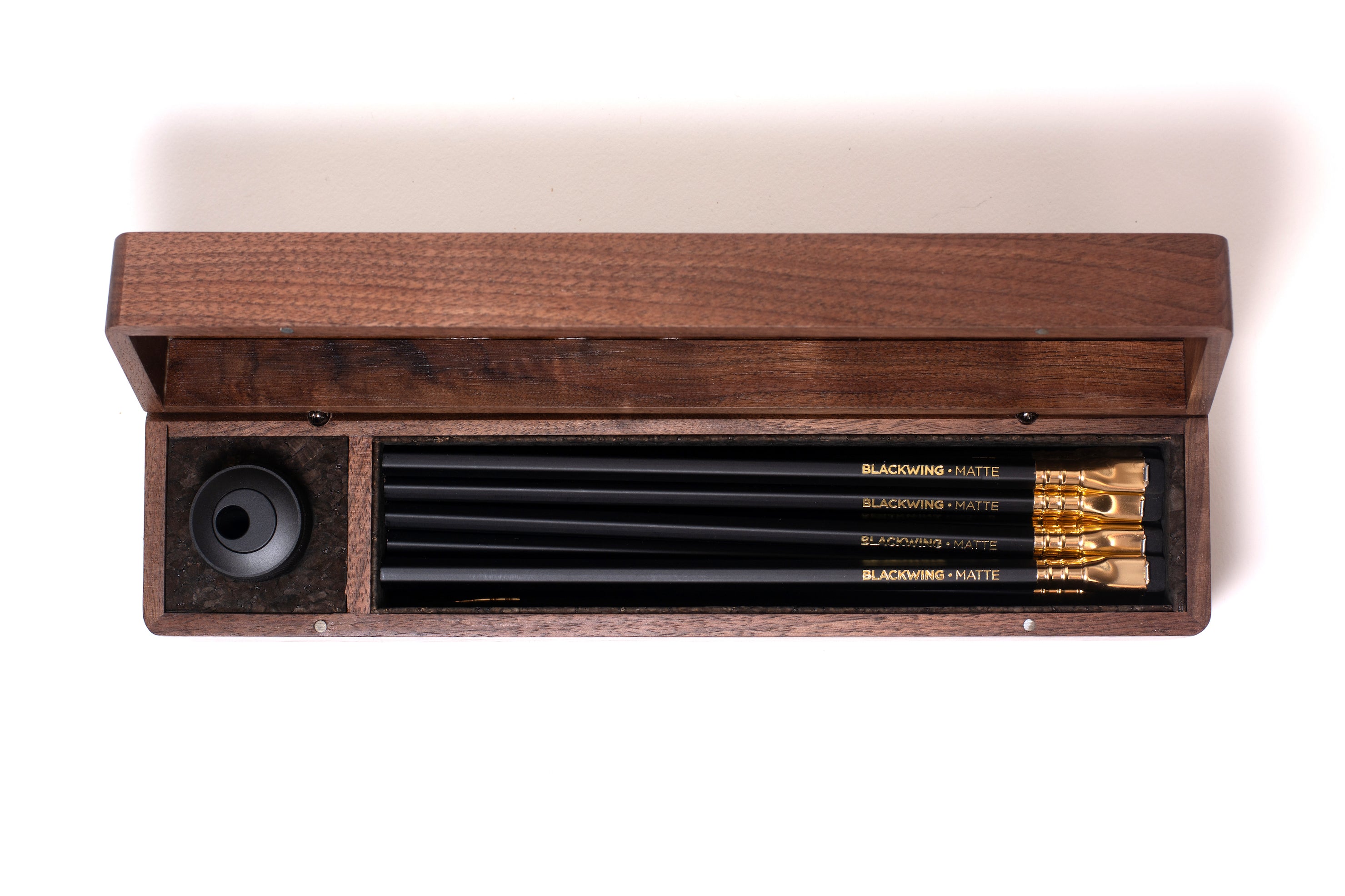 A Blackwing Walnut Box with a sharpener included.