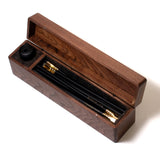 A Blackwing Walnut Box containing various Blackwing pencils and a sharpener.