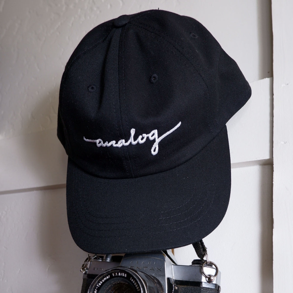 An Analog Hat resting on a camera.