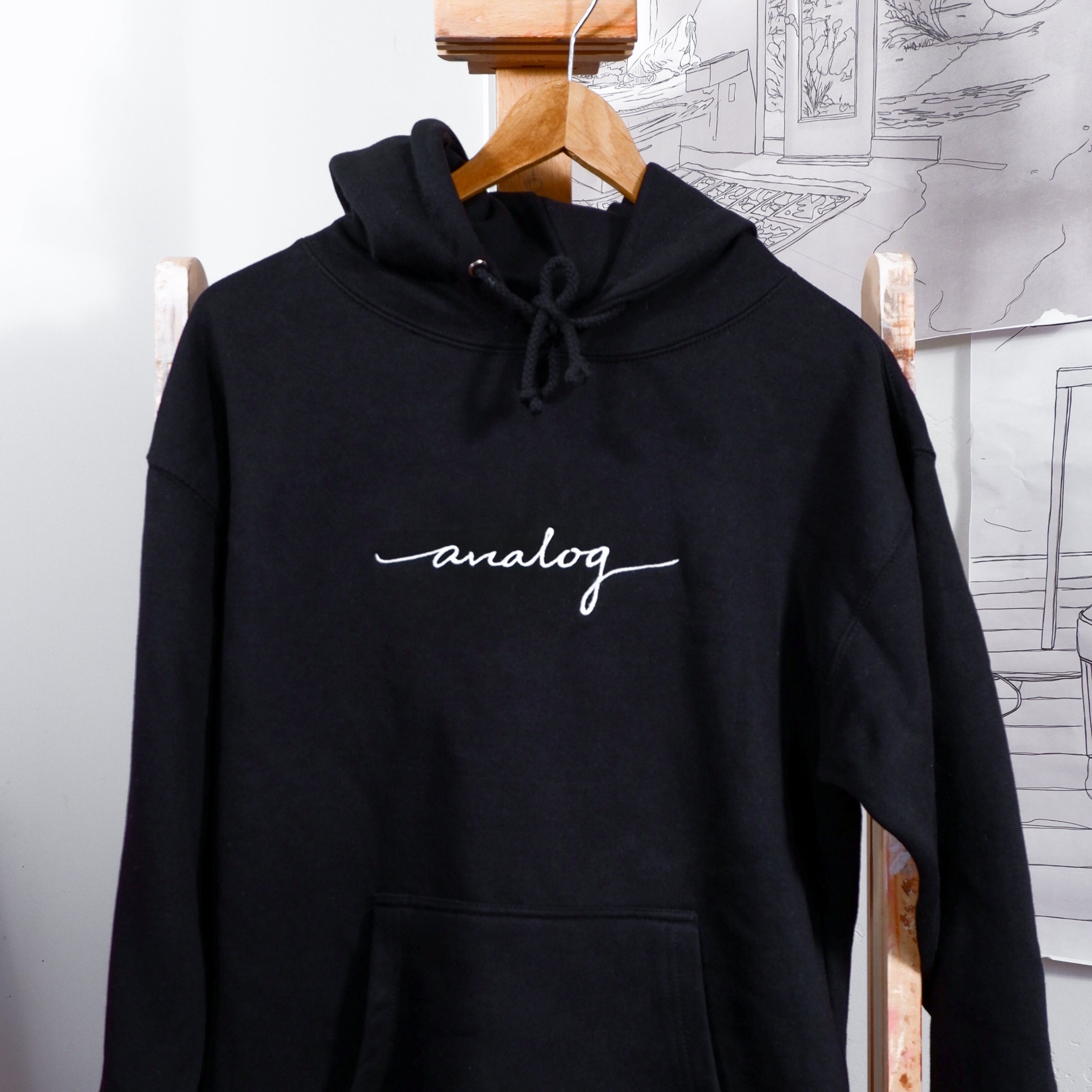 A black Analog Hoodie with the word yogi written on it.