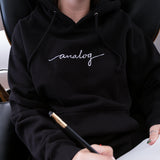 A person in an Analog Hoodie holding a Blackwing pencil.