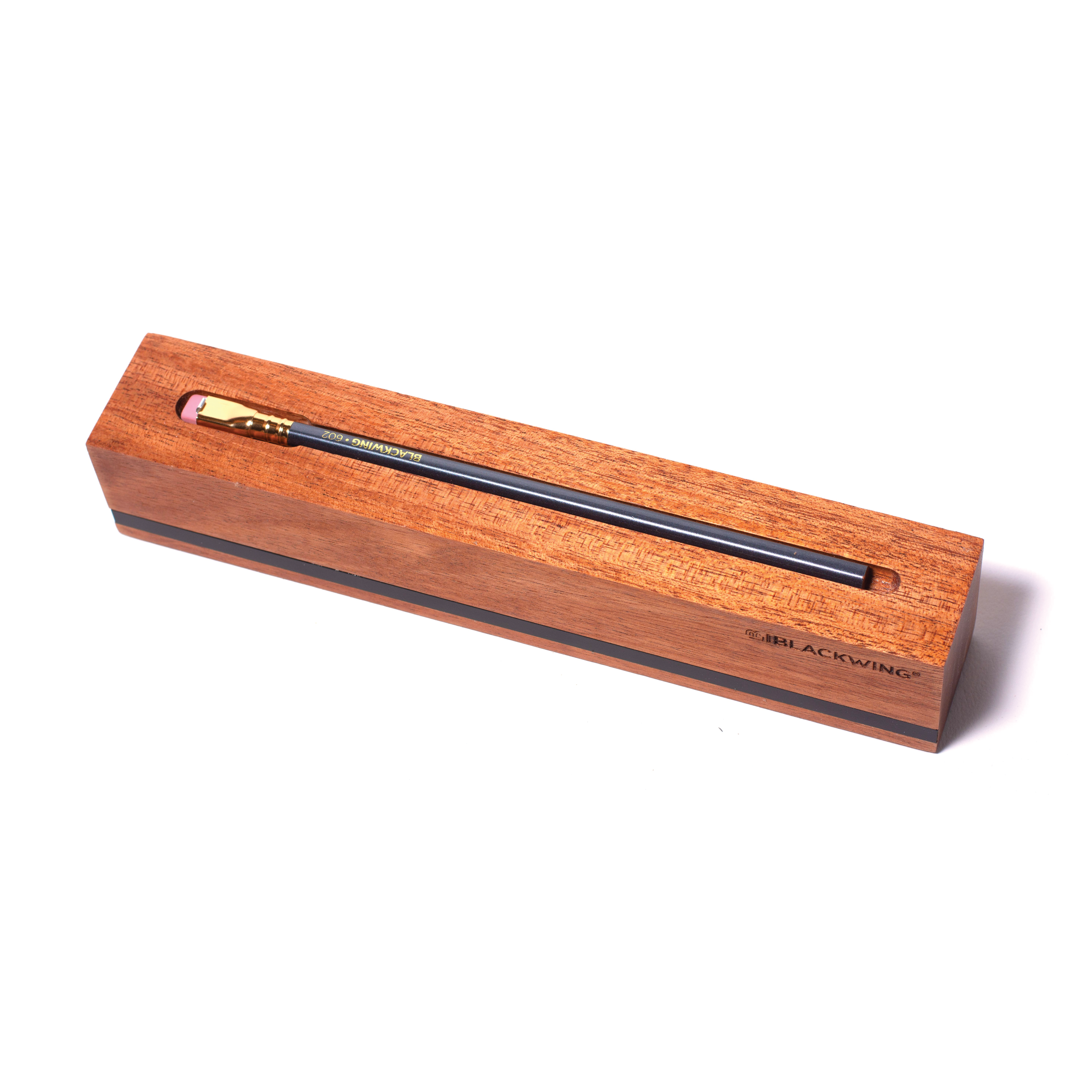 A Blackwing Flat Single Pencil Display in a wooden box on top of a white surface.
