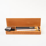 A Blackwing French Wood Box with French wood pencils and a sharpener.