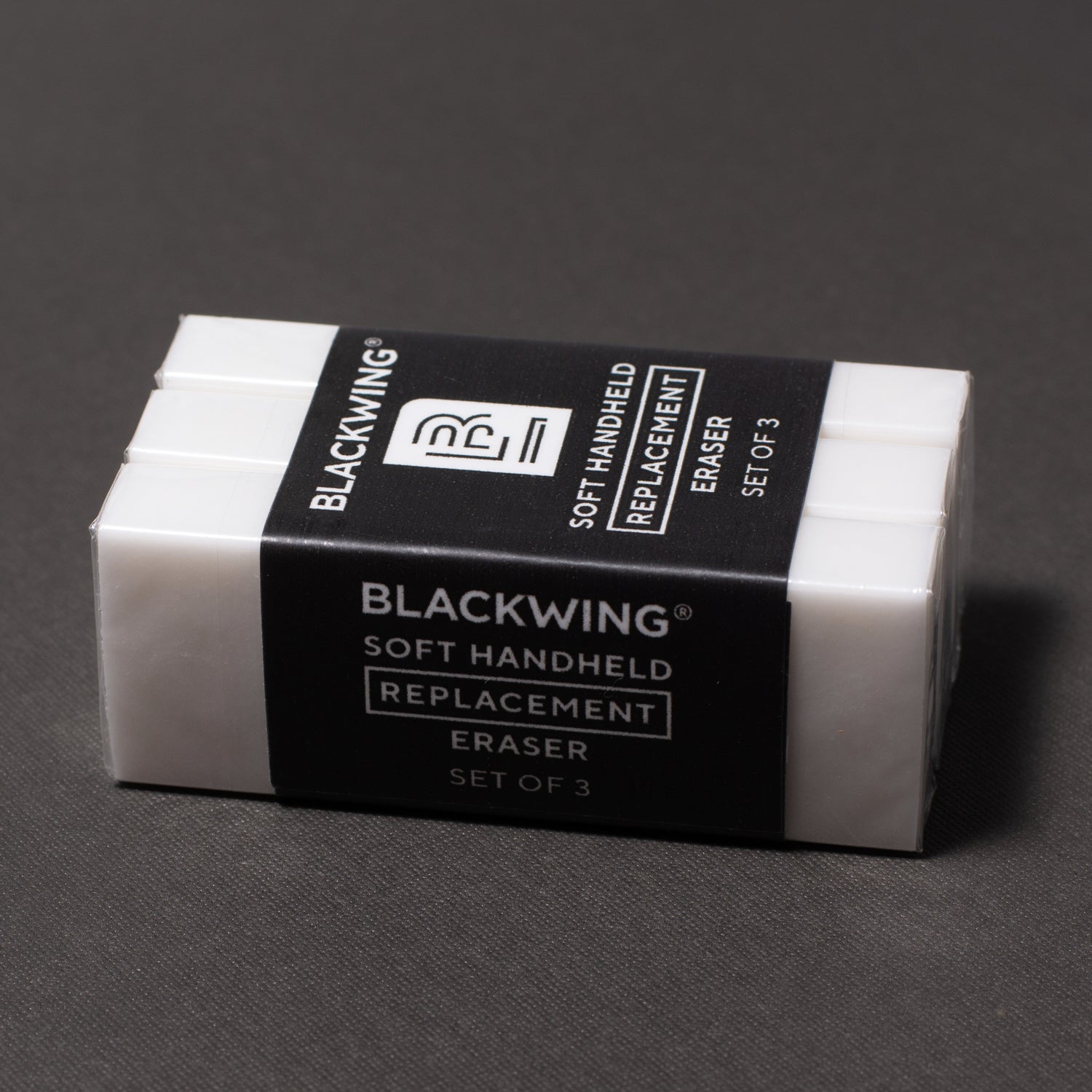 Blackwing Handheld Eraser Replacements - Set of 3 with holder on a grey background.