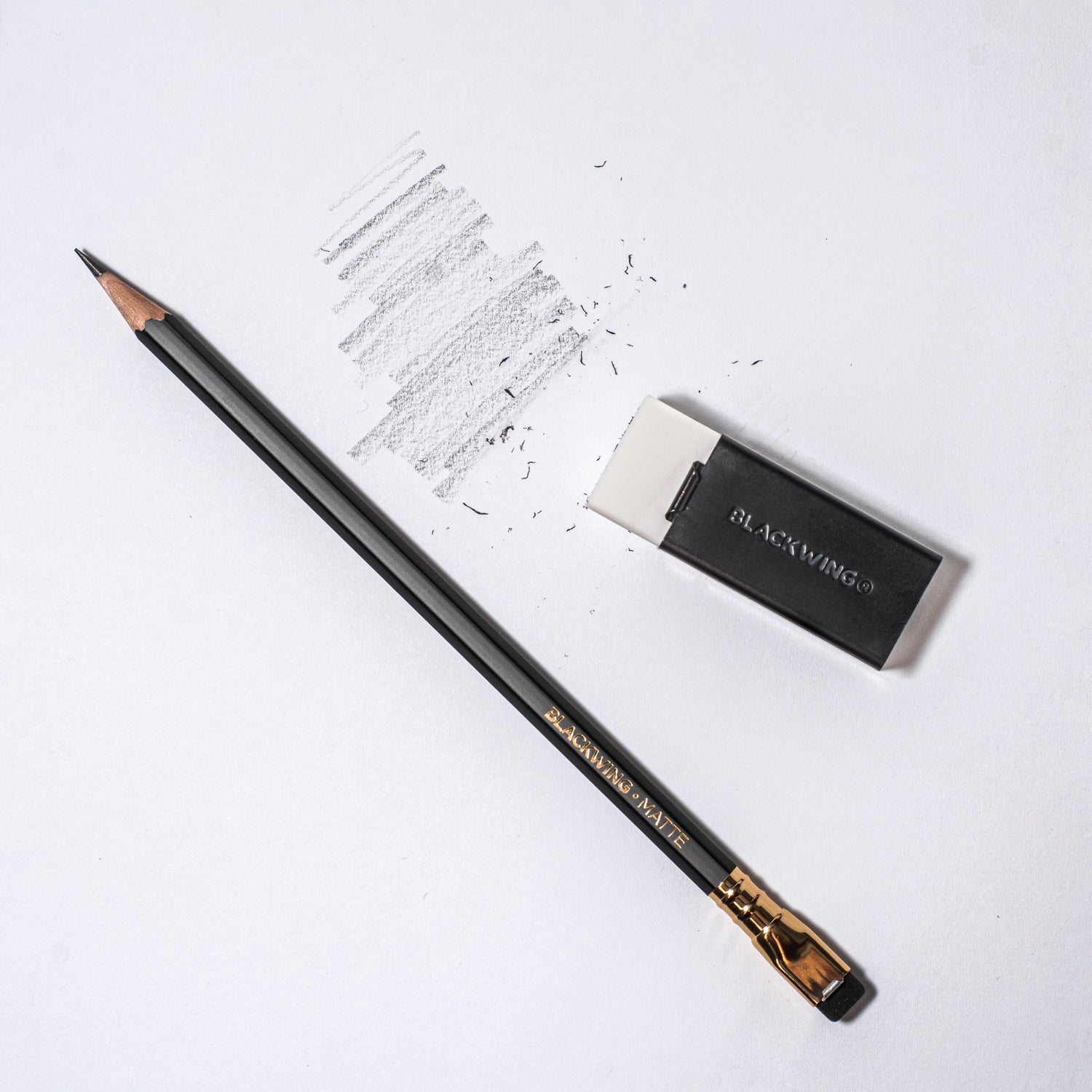 A Blackwing Soft Handheld Eraser + Holder and an eraser on a white surface.