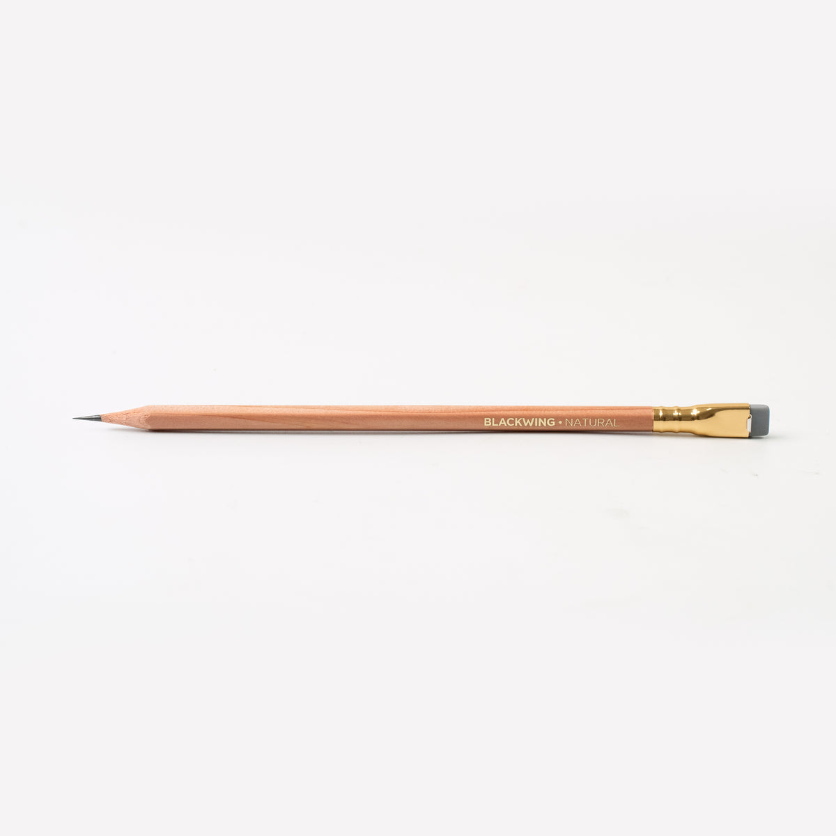 A Blackwing Natural pencil on a white surface.