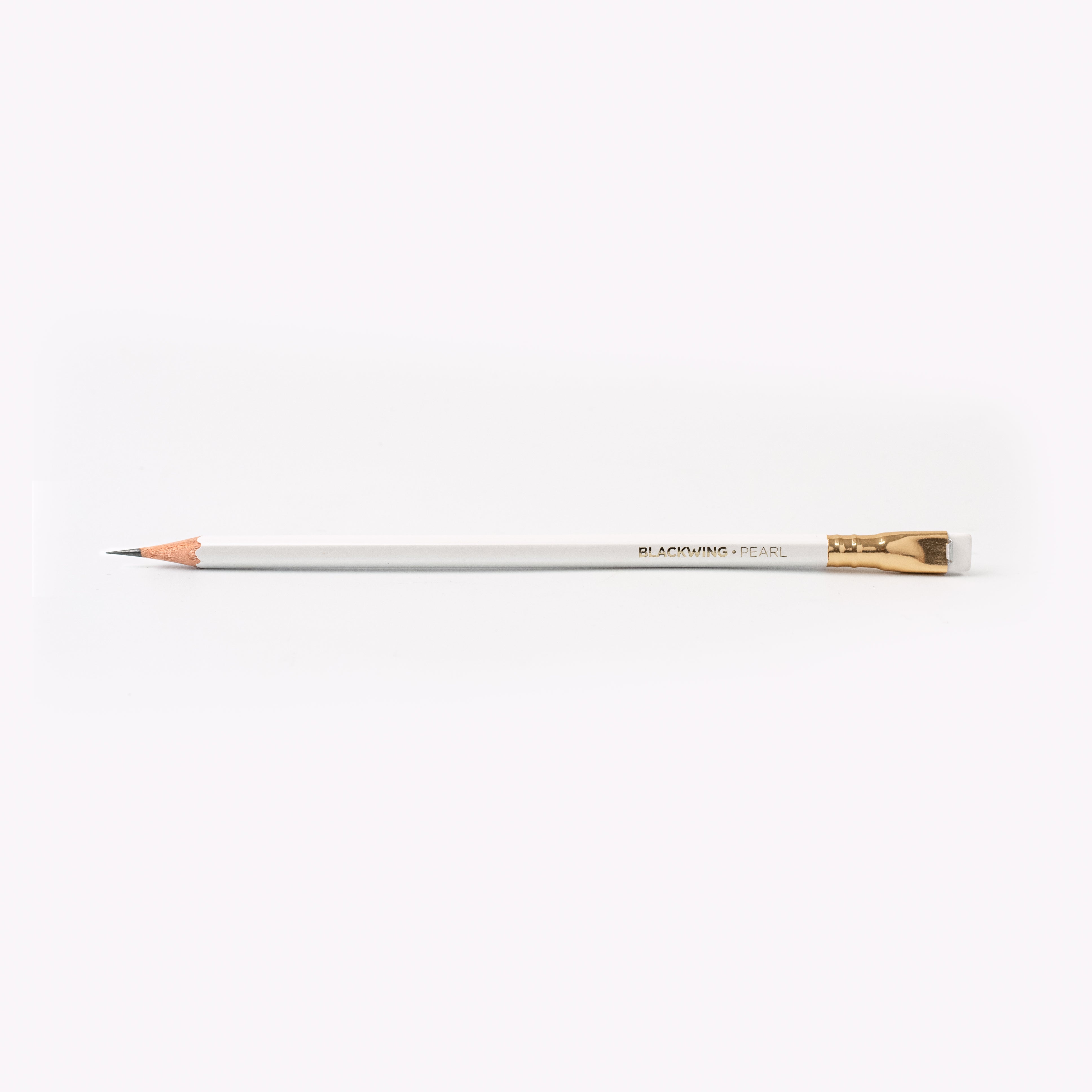 A Blackwing Pearl pencil with a graphite core on a white surface.