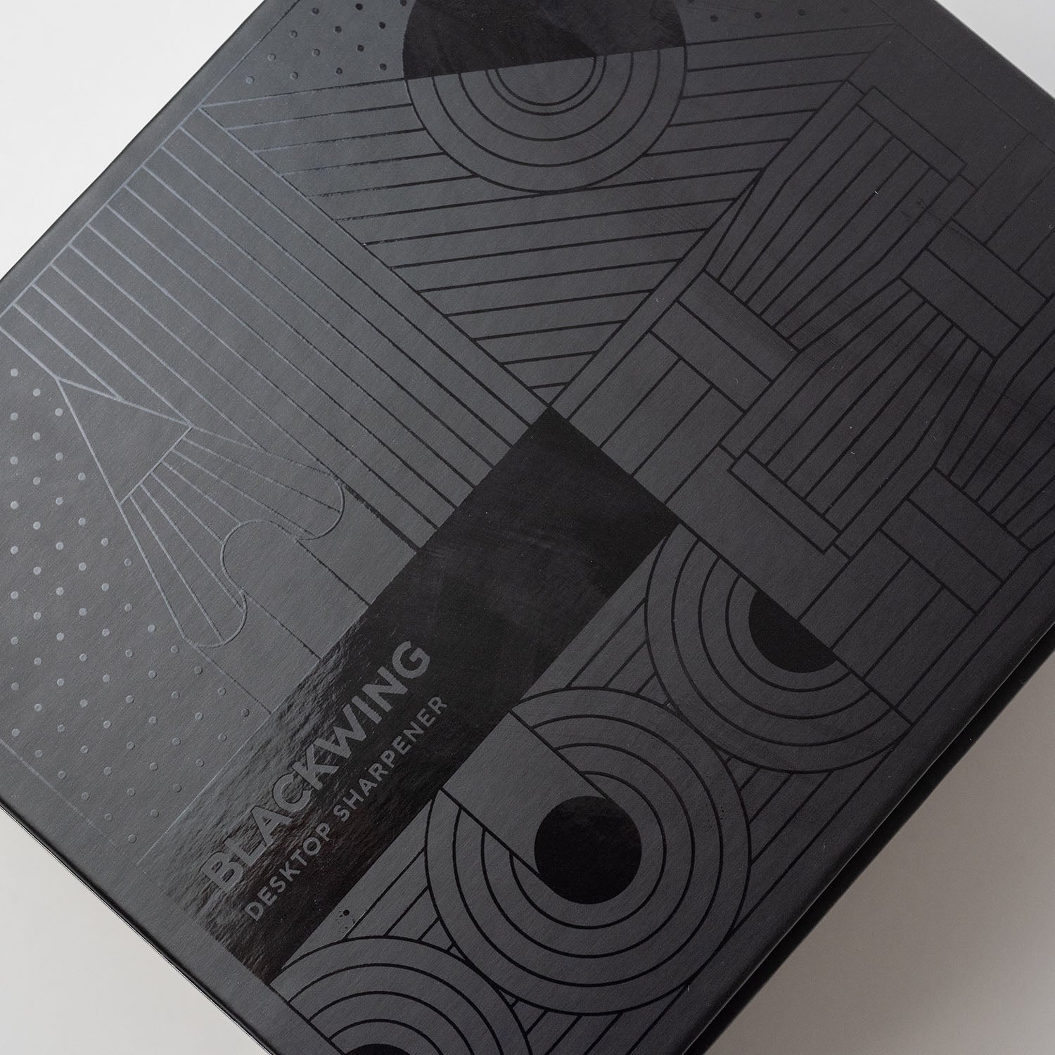A black box with geometric designs, inspired by the Blackwing Desktop Sharpener.