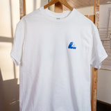 A white "Slow Down" T-shirt with a blue whale design on it.