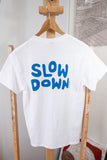 A "Slow Down" T-Shirt with blue text inspired by a Blackwing pencil design.