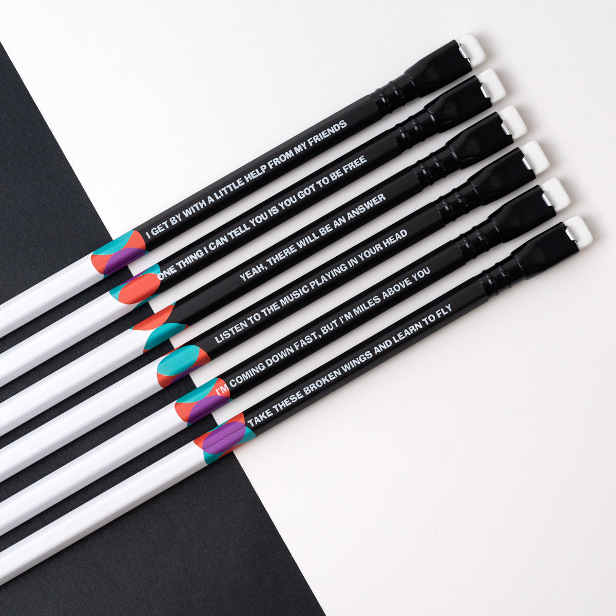 A collection of Blackwing Volume 192 (Set of 12) pencils with writing on them, inspired by the legendary songwriting duo of Lennon and McCartney.