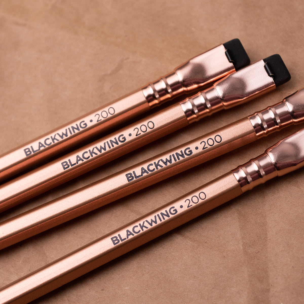 A set of Blackwing Volume 200 (Set of 12) pencils resting on a brown paper, perfect for sparking creativity in a coffeehouse setting.