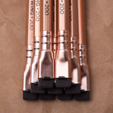 A set of Blackwing Volume 200 (Set of 12) pencils on brown paper, evoking creativity in a coffeehouse setting.