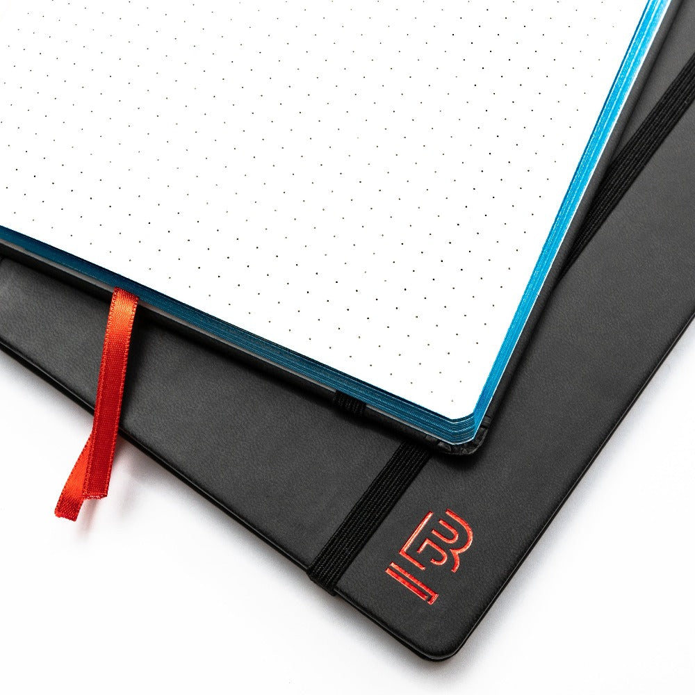 A Blackwing Volume 6 Medium Slate Notebook with a red ribbon on top, perfect for jotting down ideas with an entrepreneurial spirit.