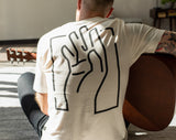 A man sitting on the floor with a Blackwing "B" Blueprint T-Shirt.
