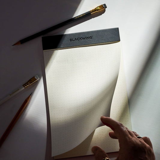 Blackwing legal pad and pencils on a clean desk