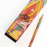A book with a vibrant abstract cover design, inspired by the Grateful Dead, lying next to a Blackwing Volume 710 (Set of 12) pencil on a white surface.