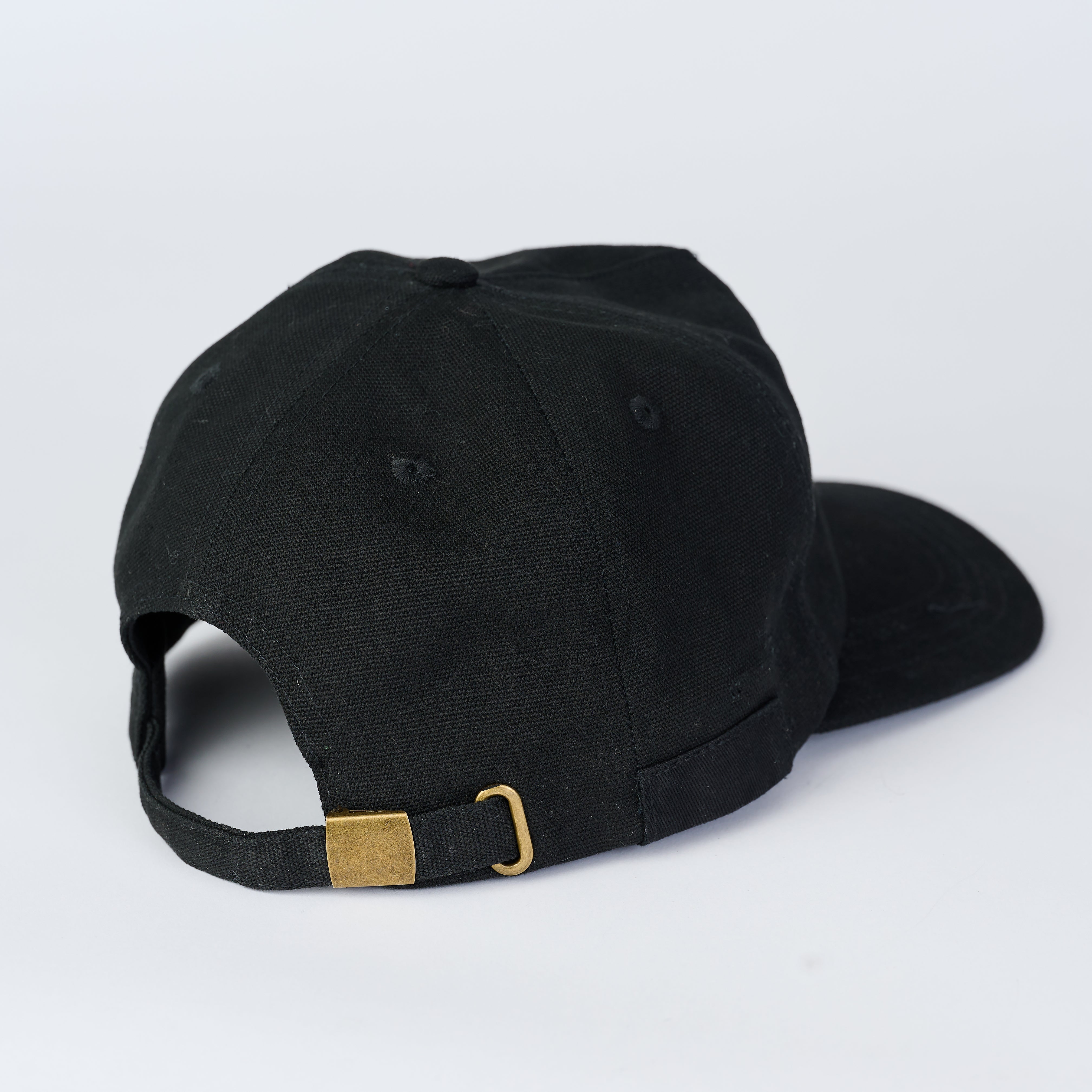 Black adjustable cap. Features a loop on the side to hold a pencil.