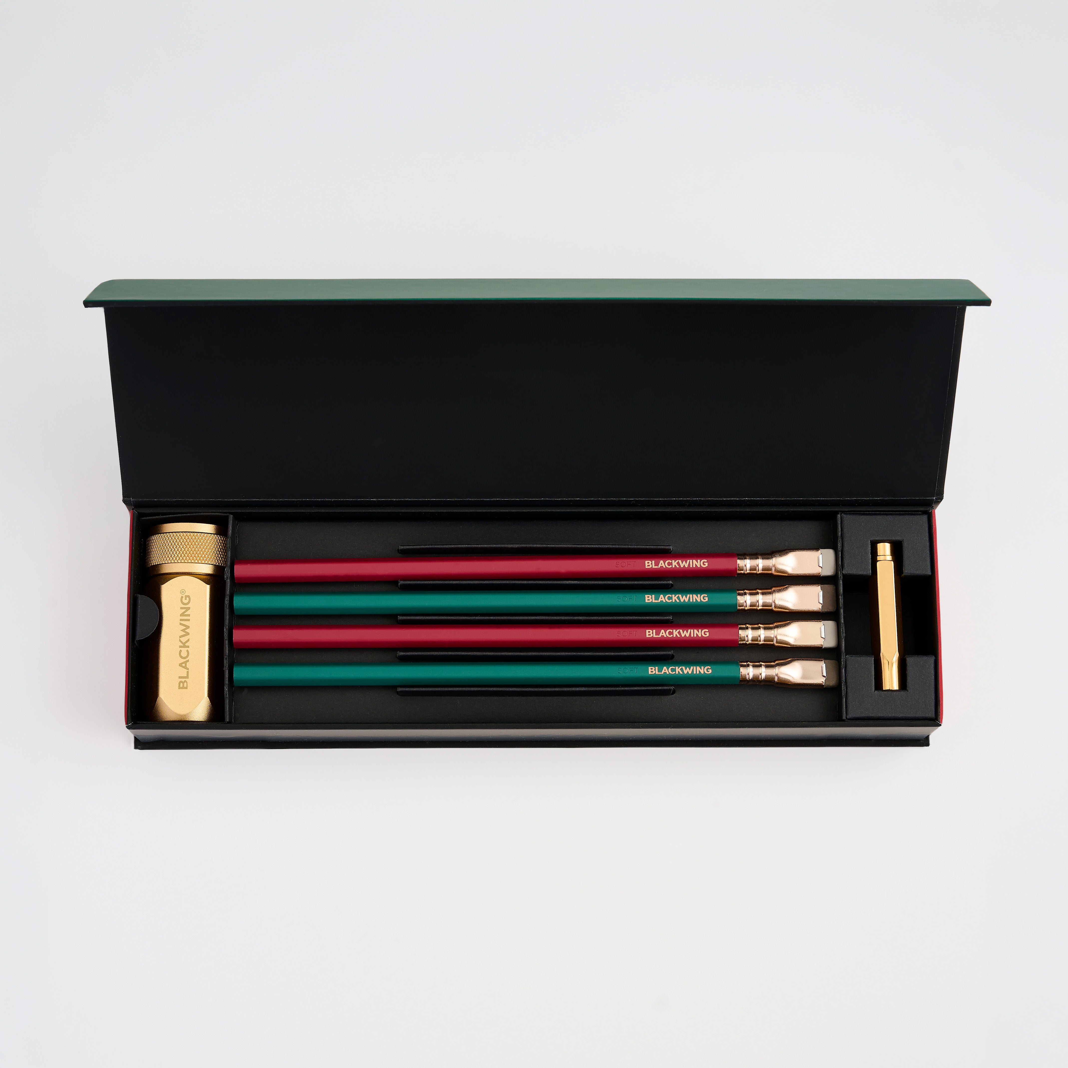 Blackwing Holiday Essentials Gift Set that includes green and red pencils, a gold sharpener, and a gold point guard.
