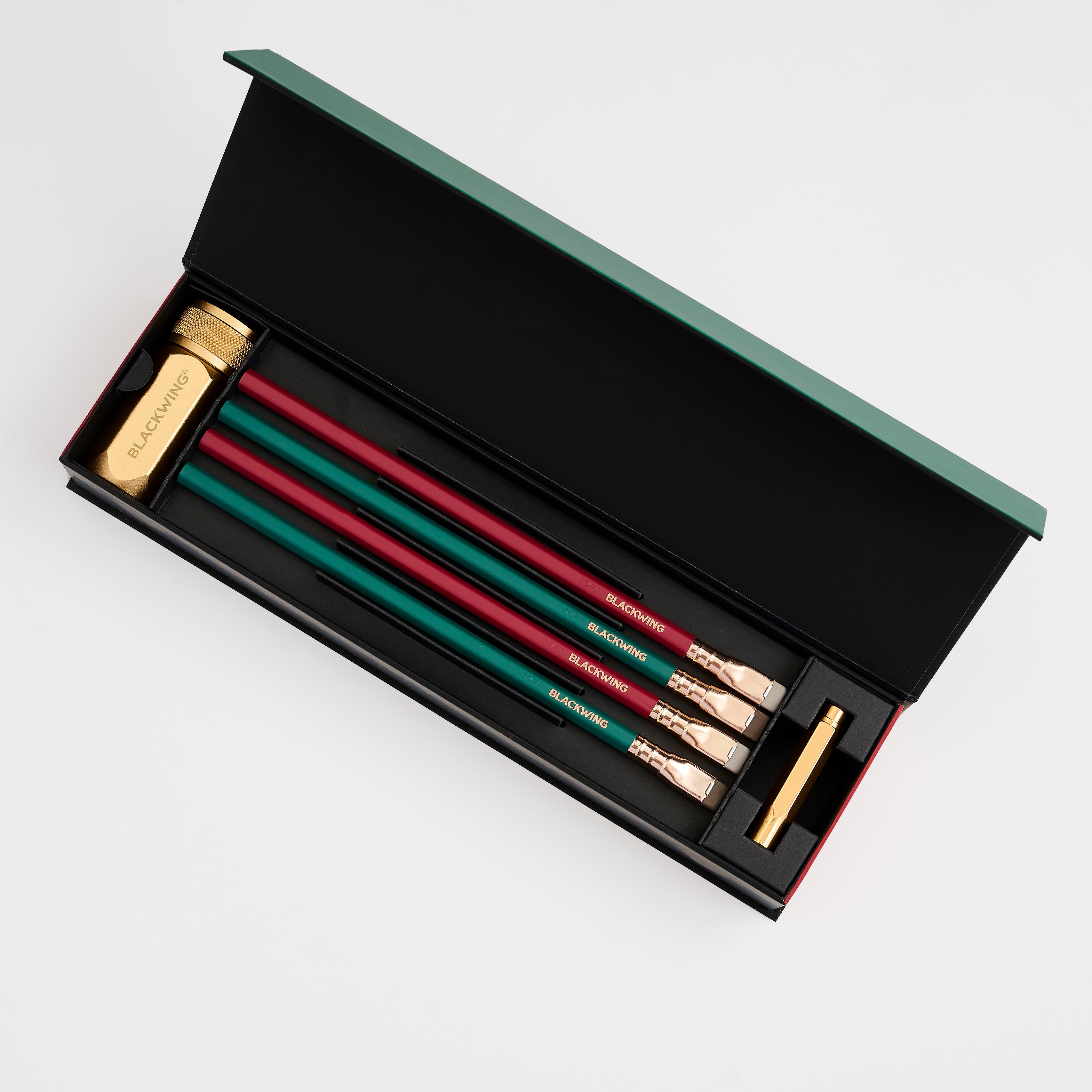 pencil gift set with 2 green pencils, 2 red pencils, a gold sharpener, and a gold pencil point guard
