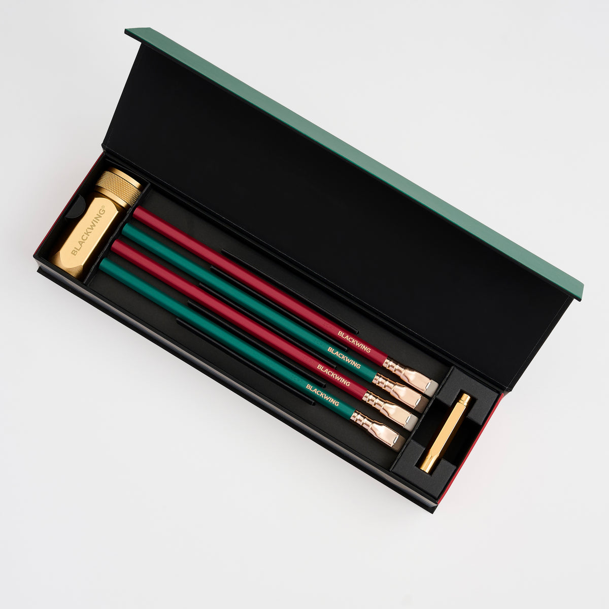 pencil gift set with 2 green pencils, 2 red pencils, a gold sharpener, and a gold pencil point guard