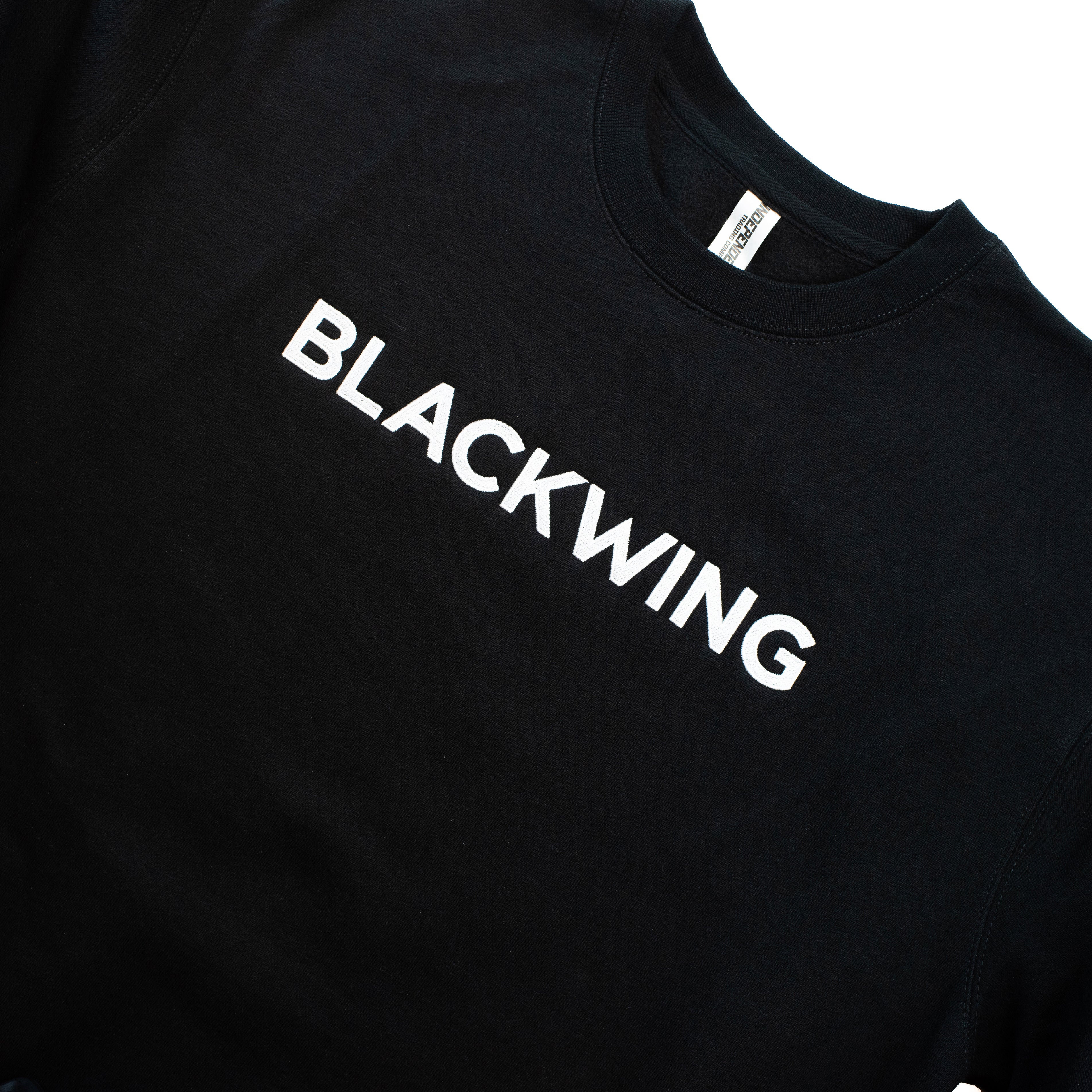 Close-up of a black crewneck sweatshirt with 'BLACKWING' embroidered in white across the chest.