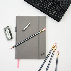 Blackwing grey hardcover notebook, 602 pencils, silver one-step sharpener, and silver point guard
