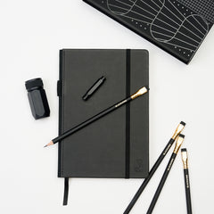 Stationery Set with black hardcover notebook, black pencils, black one-step sharpener, and black point guard