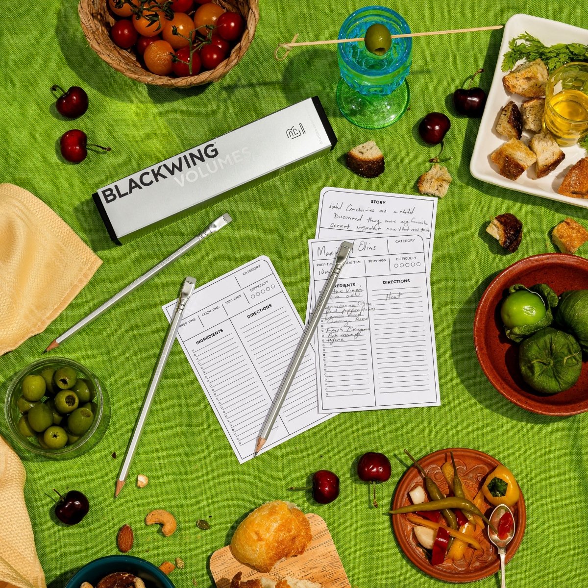 Blackwing Volume 140 pencils and recipe cards on a green tablecloth