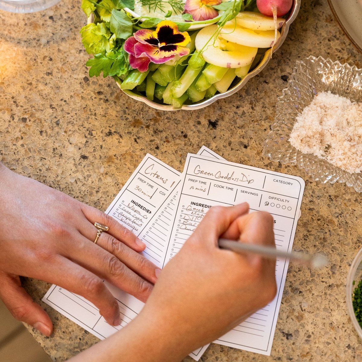 Person writing with a Blackwing Volume 140 culinary pencil on a recipe card