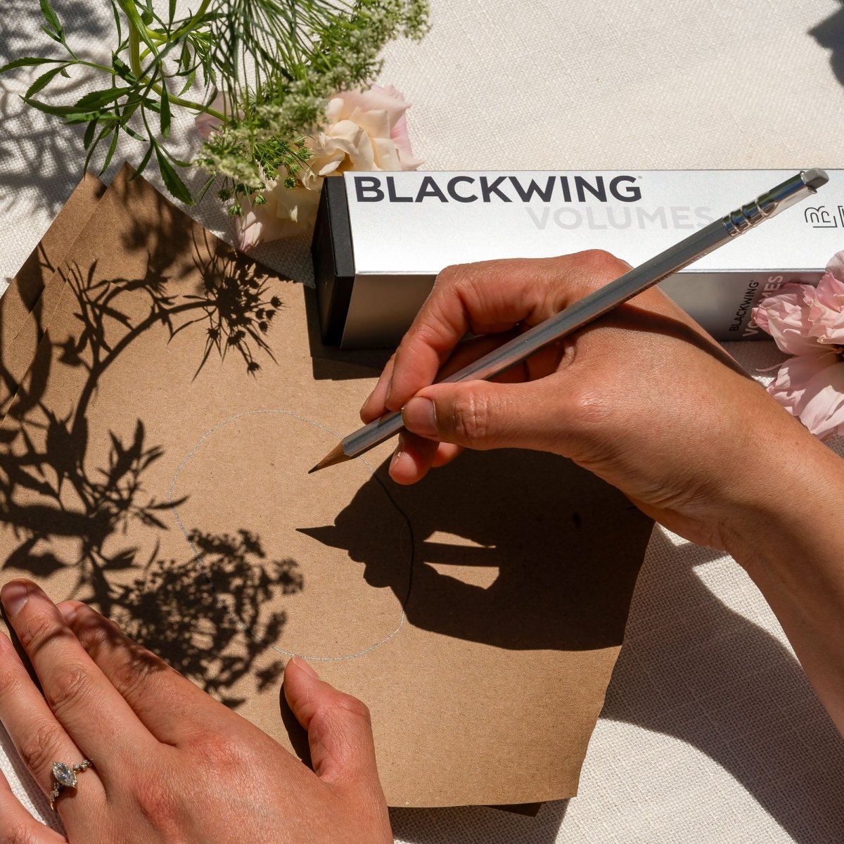 person writing with a Blackwing Volume 140 pencil