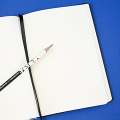 Open notebook with a pencil on a blue background