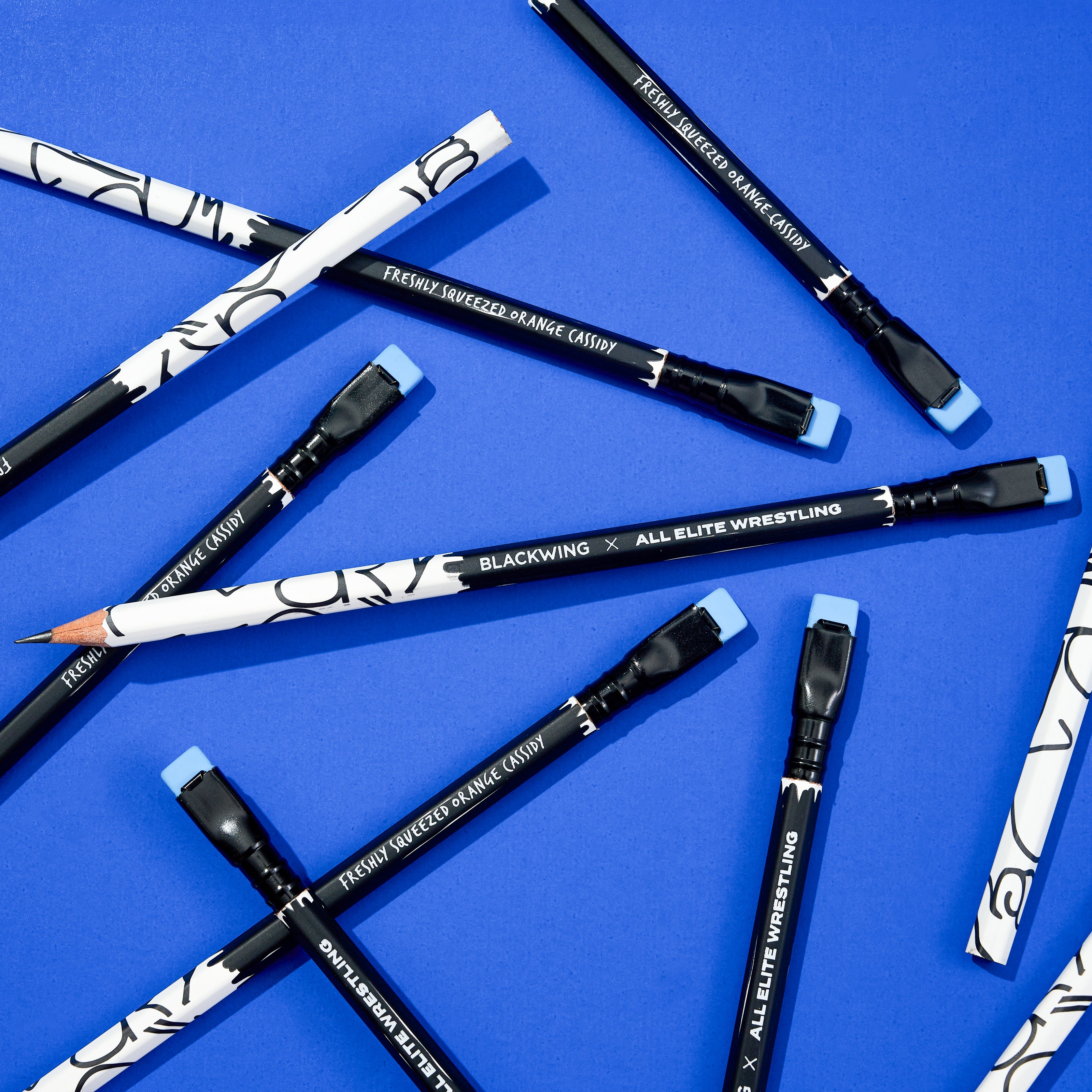 Blackwing pencils with wrestling-themed designs on a blue background