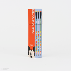 A boxed set of pencils standing upright on a clean white background. The packaging is bright red on the left with the word BLACKWING in large white letters and a Mickey Mouse face at the bottom, while the right side is light blue and shows the pencil barrels with cartoon graphics.