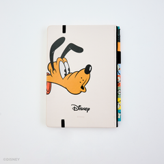 The back of a Disney hardcover notebook featuring a cartoon Pluto face with a black elastic closure. There is a colorful pencil tucked into the side, photographed on a clean white background.